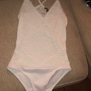 Never worn.white lace body suit.also lingerie